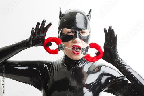 portrait of woman wearing latex clothes with handcuffs photo