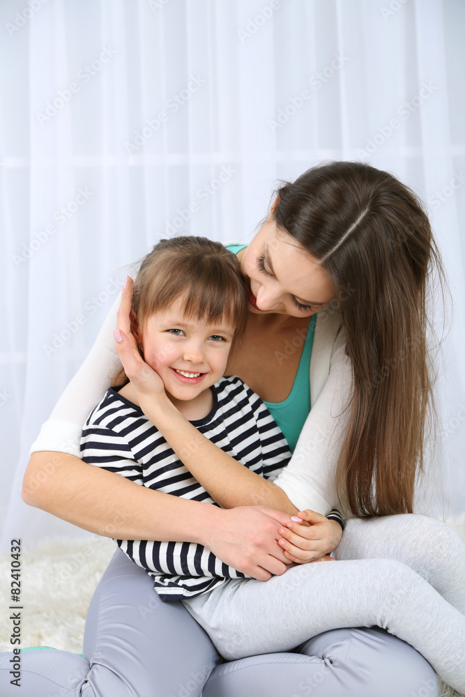 Two girls smiling on light background Two girls smiling on light background