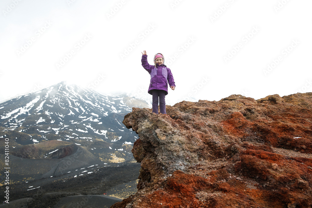 Girl celebrating reached summit of crater on Mount Etna