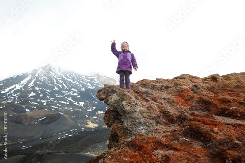 Girl celebrating reached summit of crater on Mount Etna