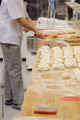Chefs forming dough in order to prepare bread