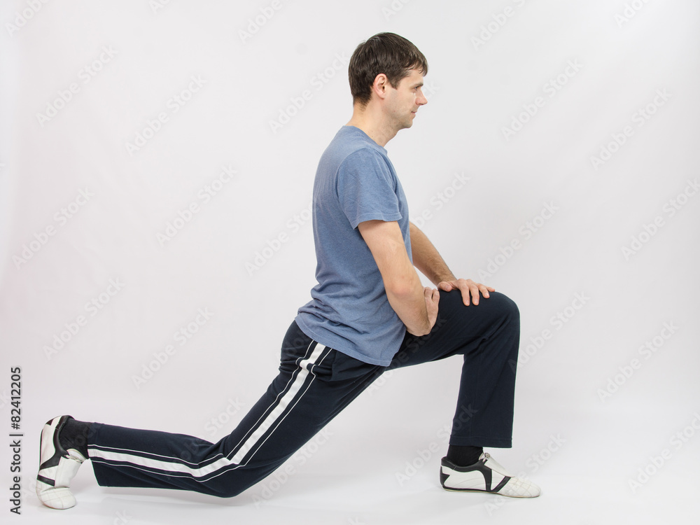 The athlete performs stretching using squats