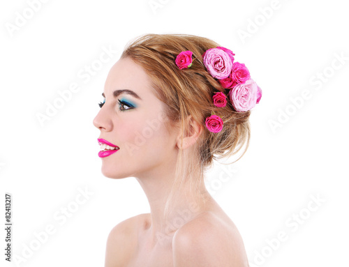 Portrait of young woman with flowers in hair isolated on white