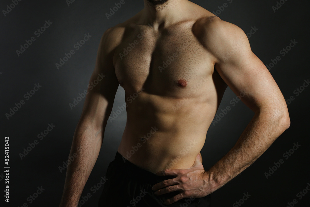 Muscle young man on dark background