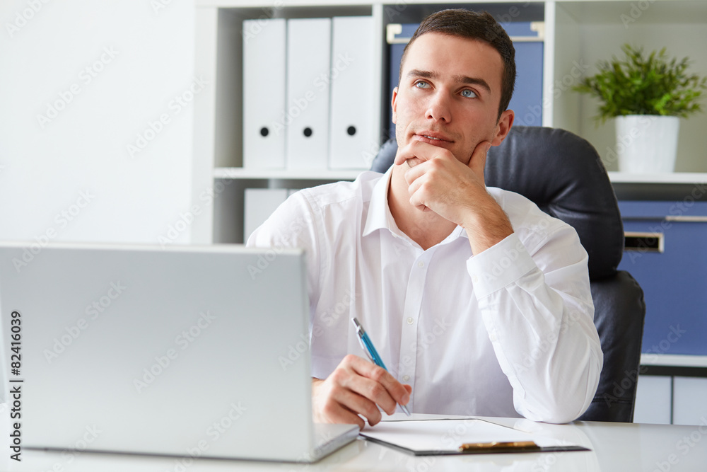 Pensive young businessman with notebook Pensive young businessman with notebook