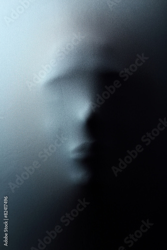 Foto Human face pressing through fabric as horror background