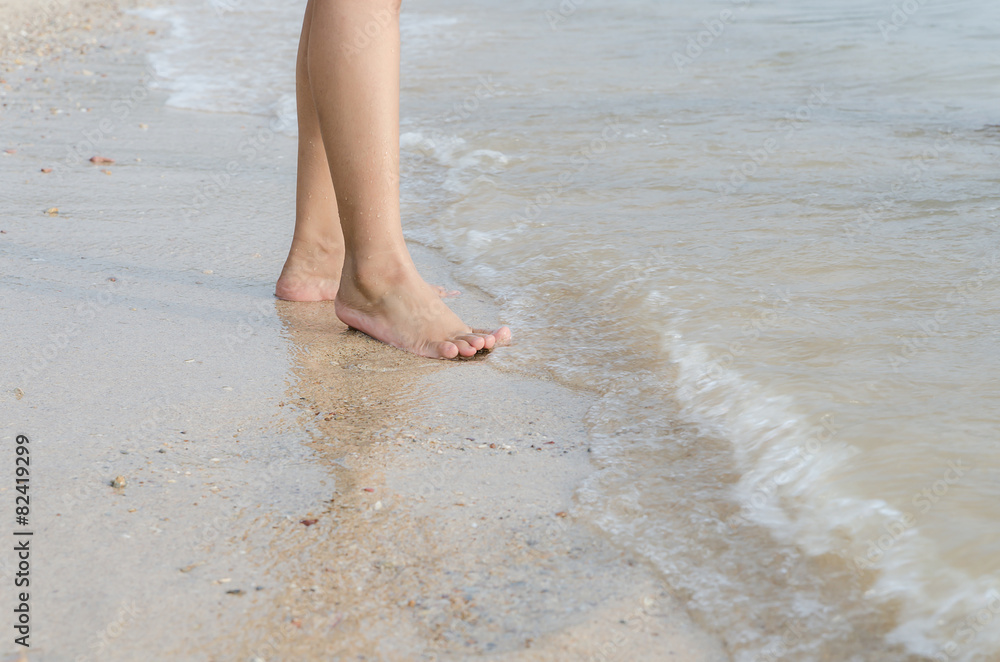 Woman feet on the beach with natural evening light Woman feet on the beach with natural evening light