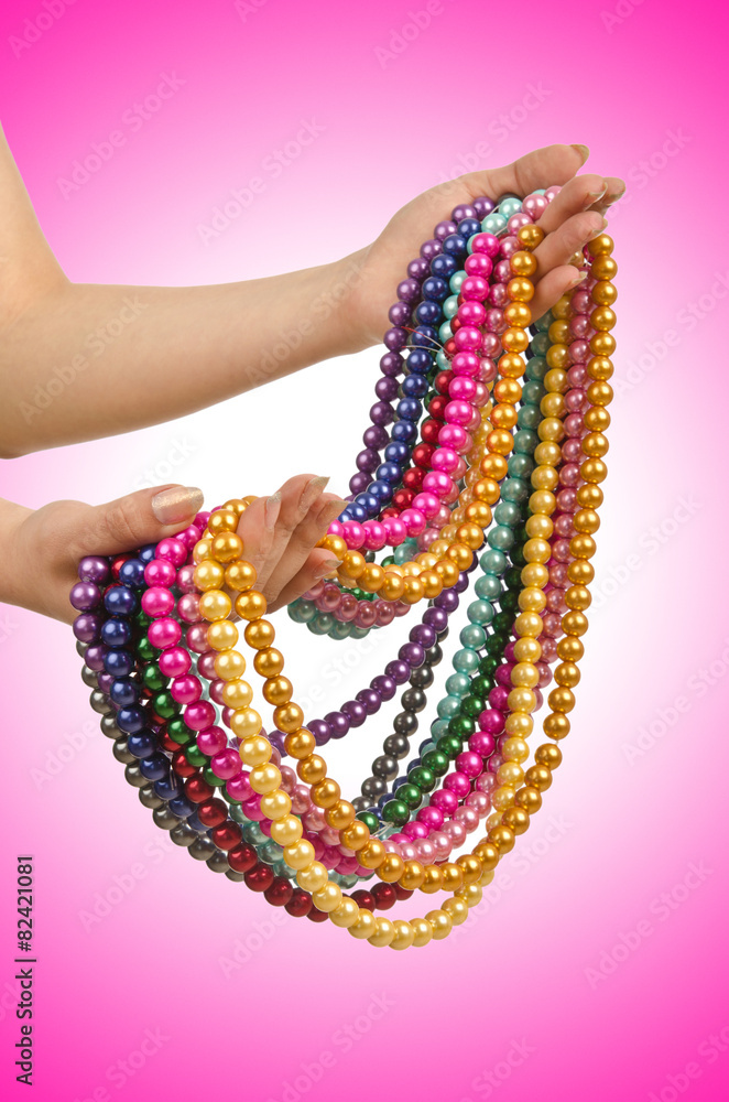 Pearl necklace in hand on white Pearl necklace in hand on white