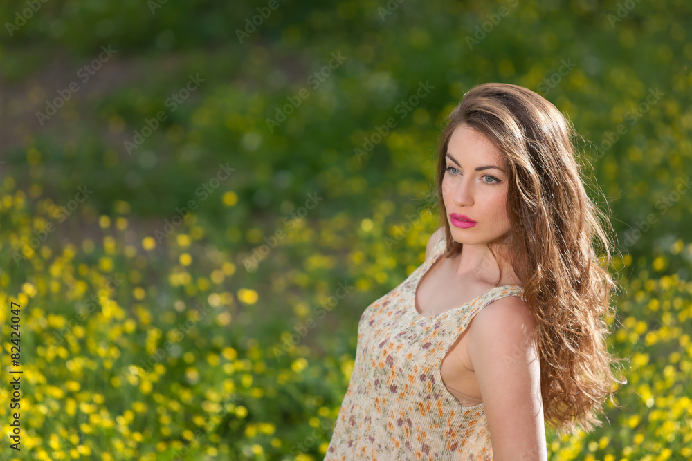 Beautiful young girl among yellow flowers Beautiful young girl among yellow flowers