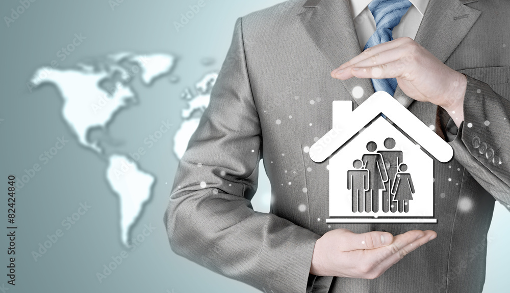 businessman protecting family in home with hands businessman protecting family in home with hands