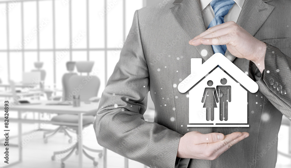 businessman protecting family in home with hands businessman protecting family in home with hands