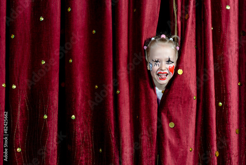 Girl Wearing Clown Makeup Peeking Through Curtains
