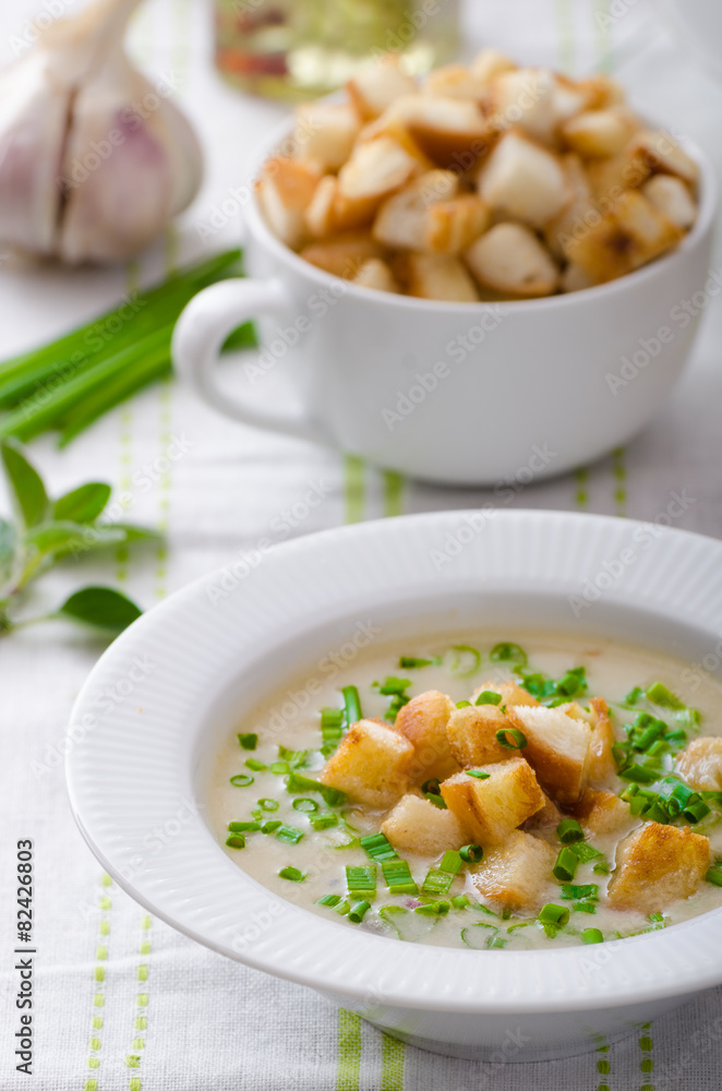 Garlic soup with croutons, spring onions and chives Garlic soup with croutons, spring onions and chives
