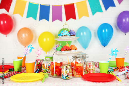 Prepared birthday table with sweets for children party photo