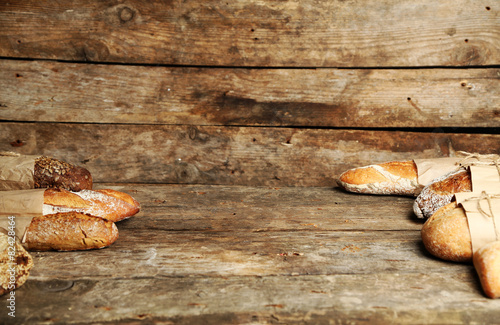 Different fresh bread, on old wooden table