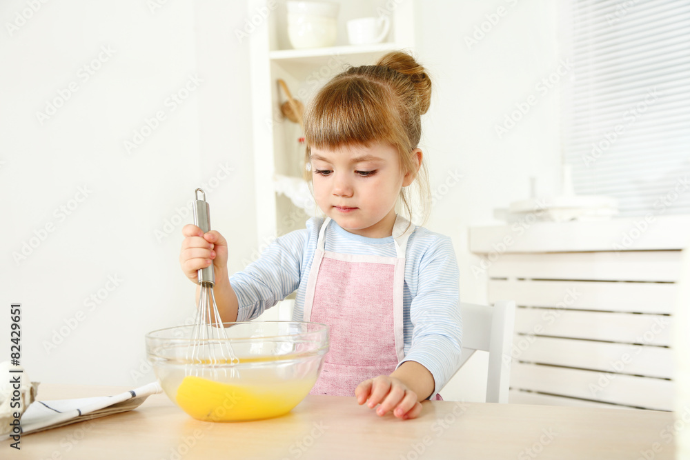 Little girl preparing cookies in kitchen at home Little girl preparing cookies in kitchen at home