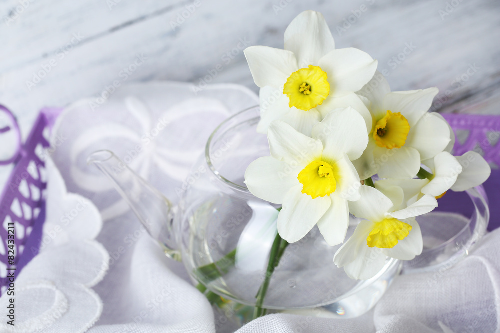 Fresh narcissus flowers on tray, closeup