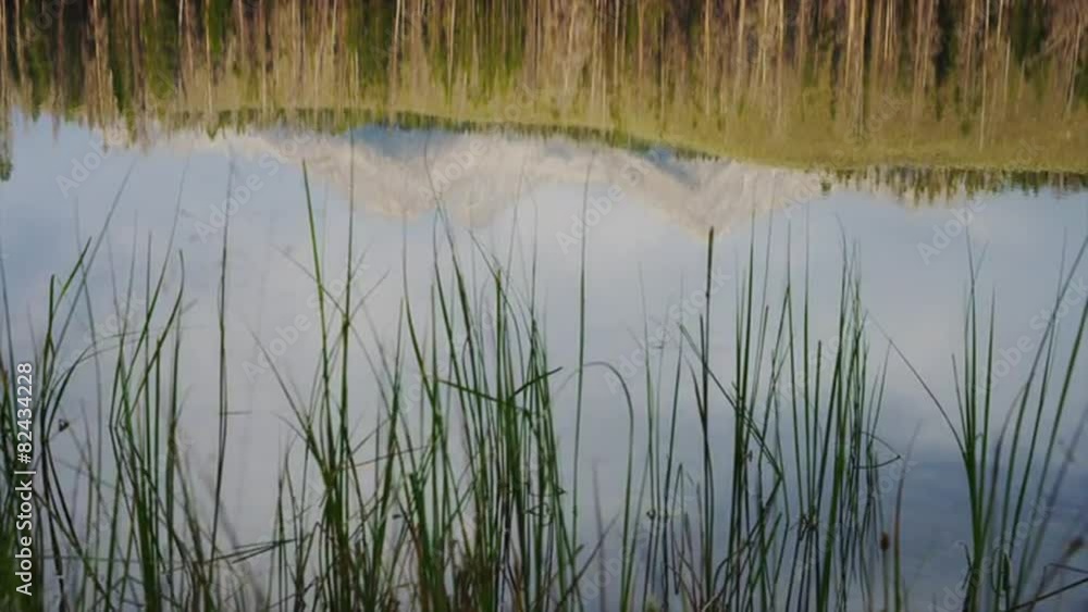 Panning slow motion medium shot of mountains reflected in calm lake / Redfish Lake, Idaho, United States Panning slow motion medium shot of mountains reflected in calm lake / Redfish Lake, Idaho, United States