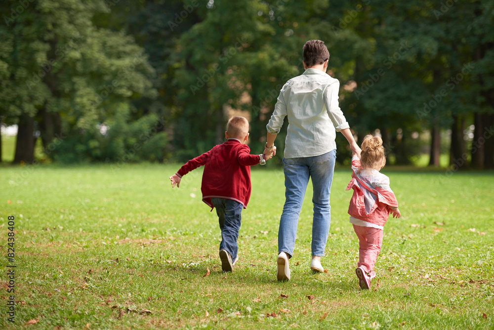 happy family playing together outdoor in park happy family playing together outdoor in park