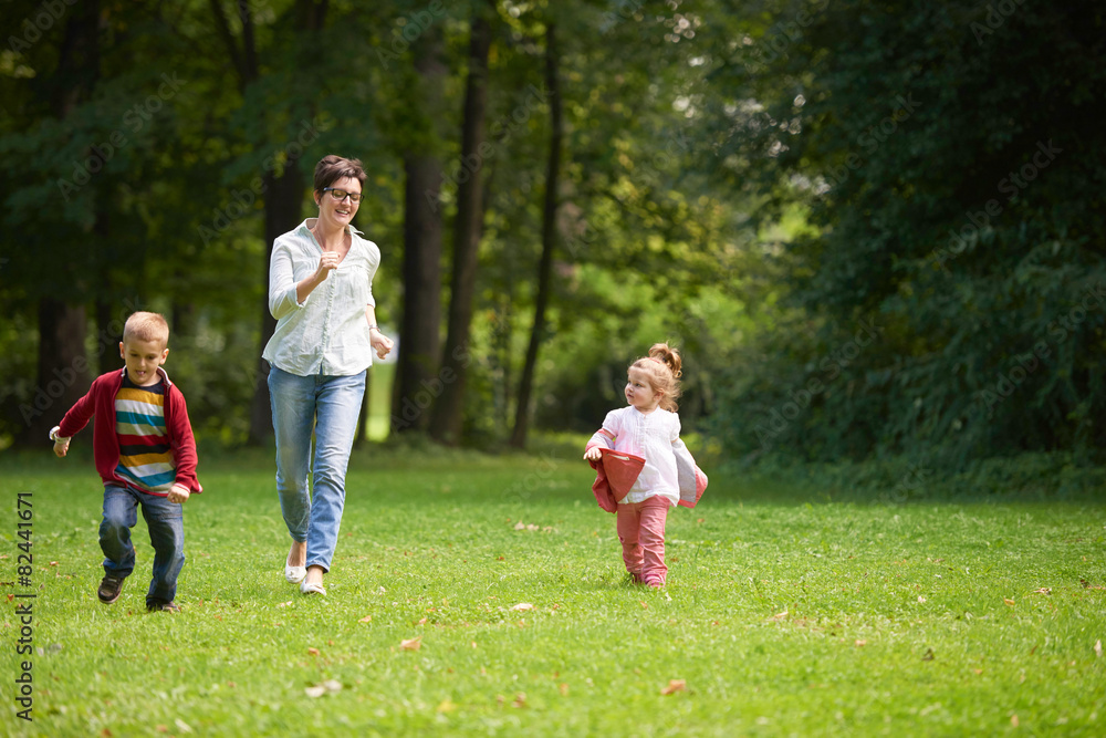 happy family playing together outdoor in park happy family playing together outdoor in park