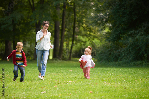 happy family playing together outdoor in park
