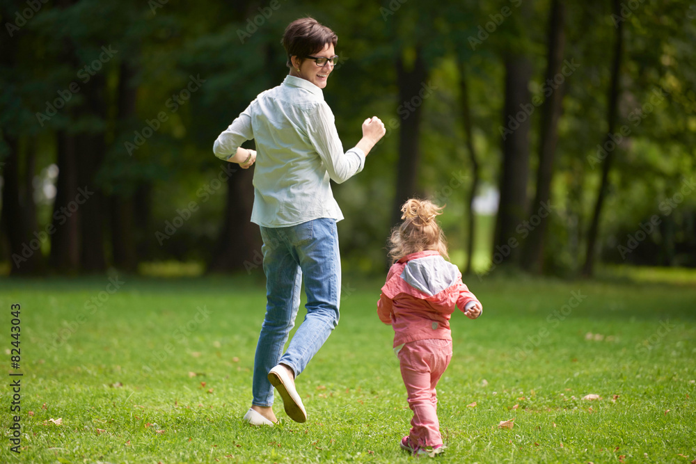 happy family playing together outdoor in park happy family playing together outdoor in park