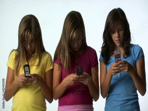 Tween girls with cell phones photo