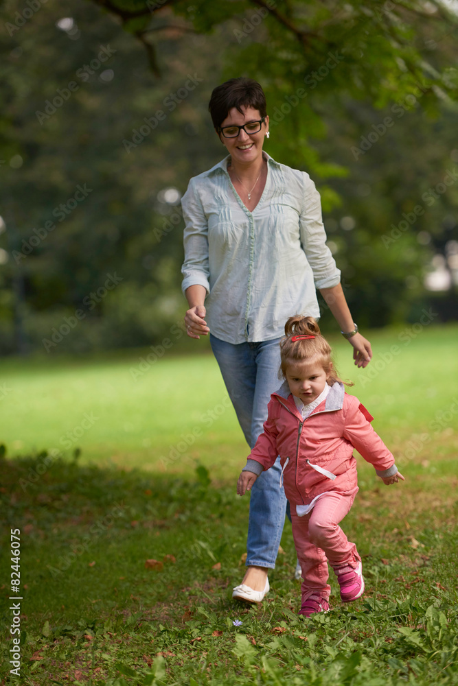 happy family playing together outdoor in park happy family playing together outdoor in park