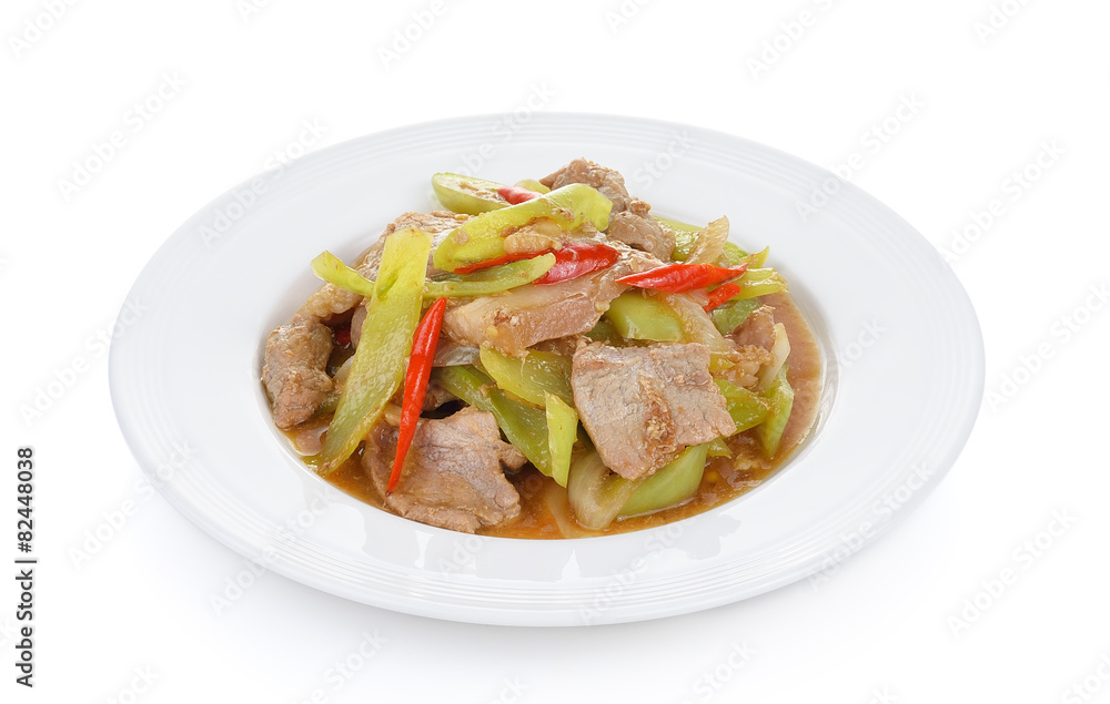 Spicy fried pork with chilli on white plate Spicy fried pork with chilli on white plate