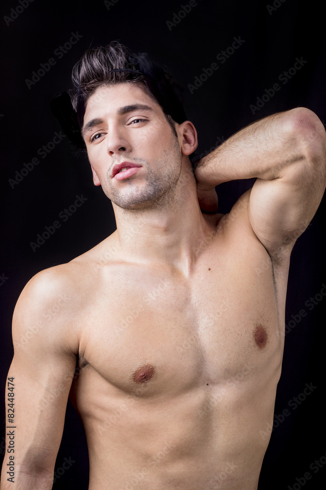 Handsome man posing on a black background Handsome man posing on a black background