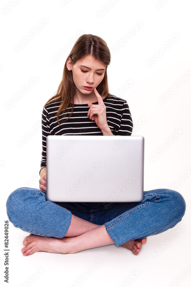 Naklejka premium Young Woman with PC hand on chin E-commerce Stock Image
