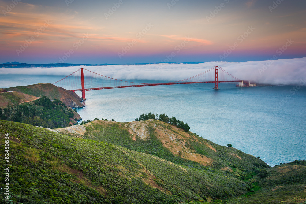 Sunset view of the Golden Gate Bridge in fog from Hawk Hill, Gol