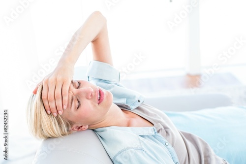 Blonde woman having headache