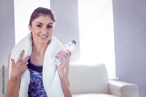 Fit woman with towel and water bottle