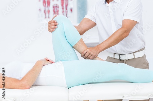 Doctor stretching his patients leg