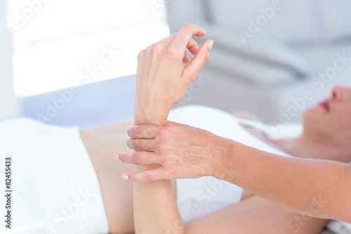Physiotherapist examining her patients wrist