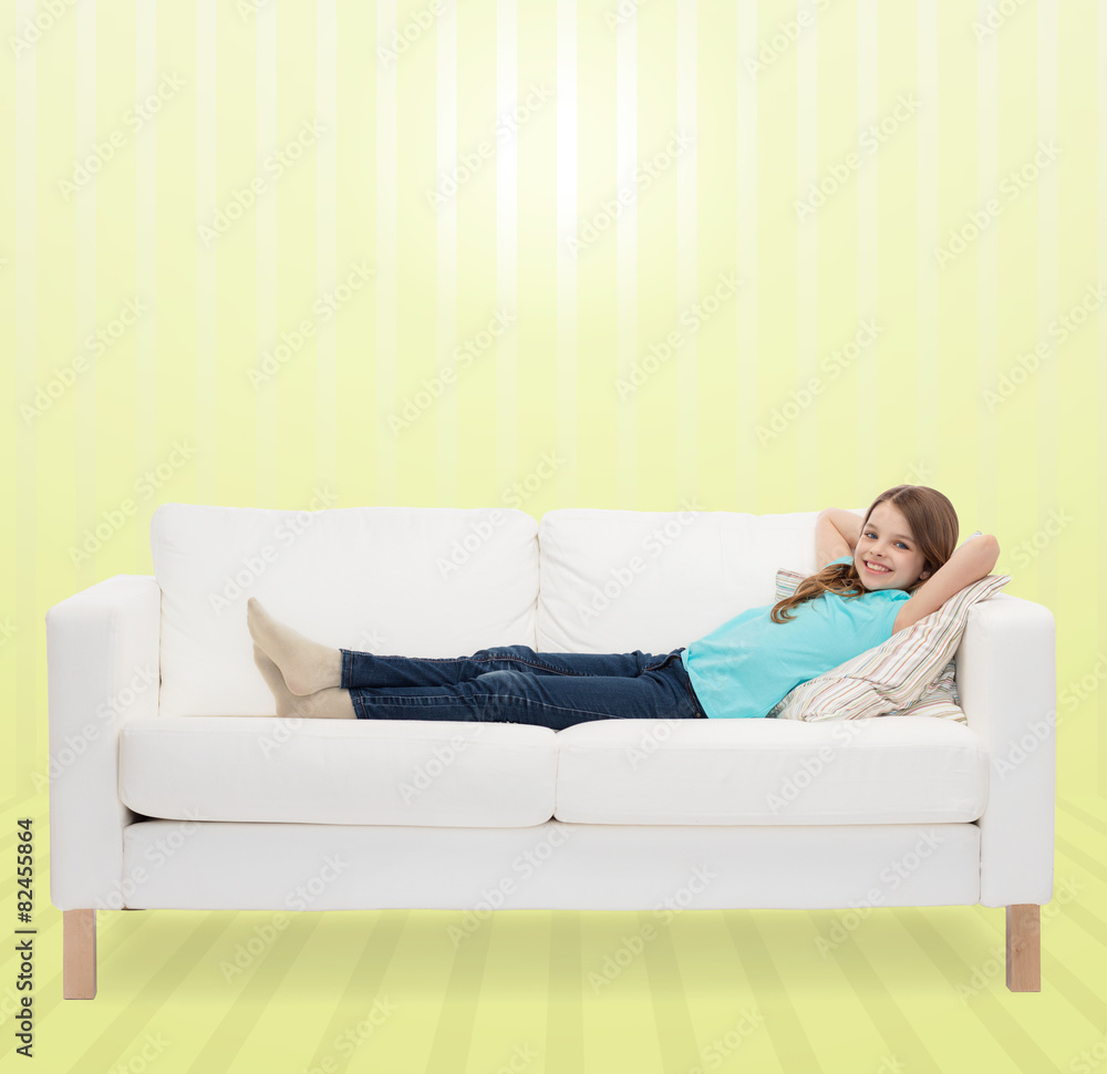 smiling little girl lying on sofa smiling little girl lying on sofa