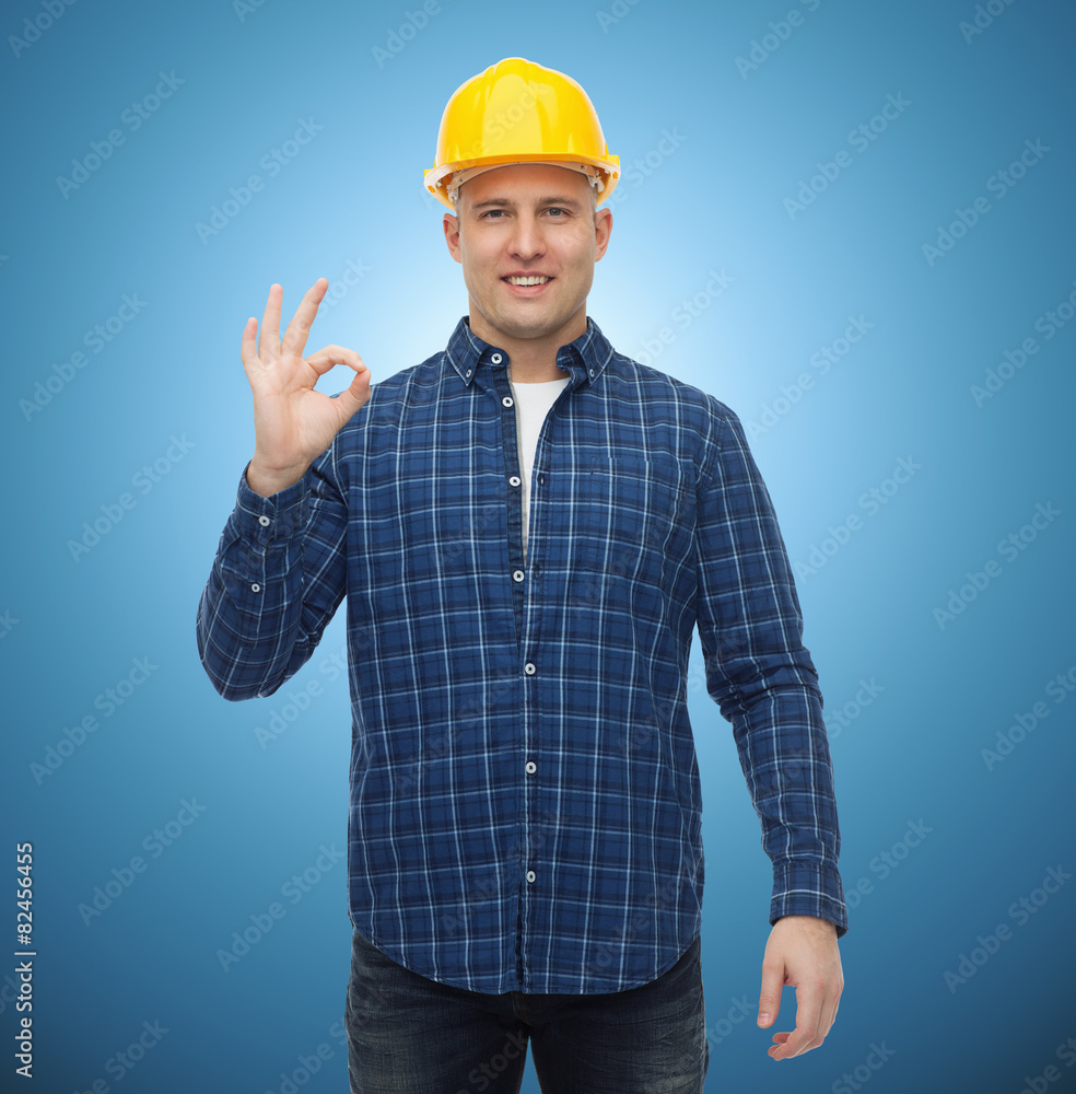 smiling male builder in helmet showing ok sign smiling male builder in helmet showing ok sign