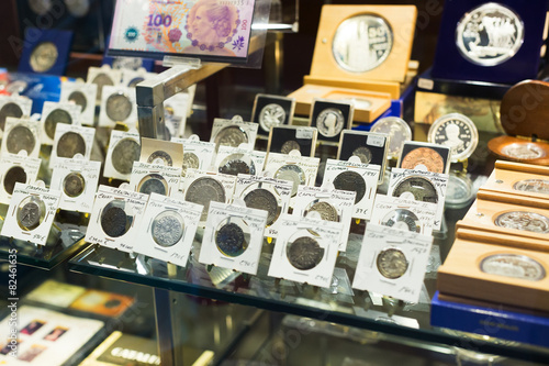 Coins on counter at numismatics store photo