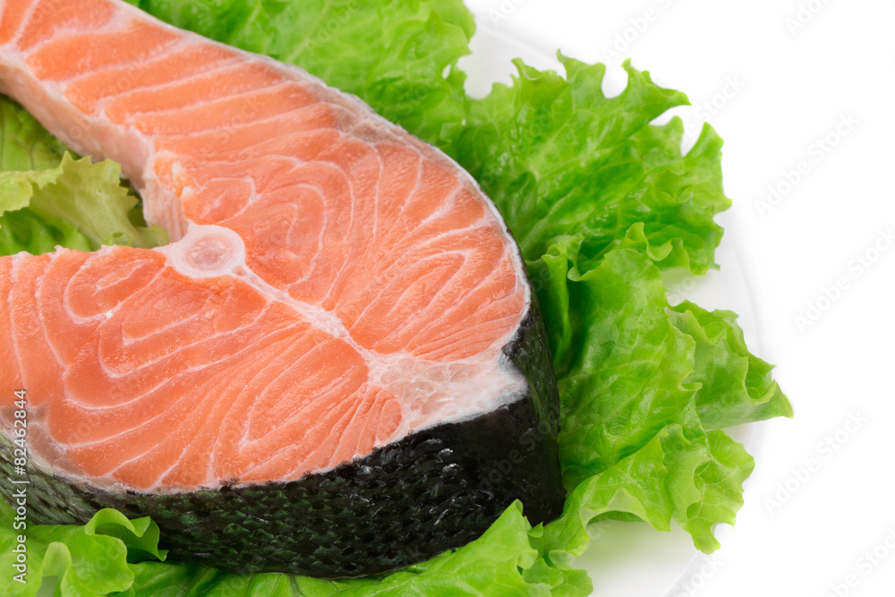 Raw salmon steak with lettuce salad. Raw salmon steak with lettuce salad.