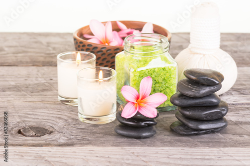 Traditional herbal compress ball, stones and candles close-up