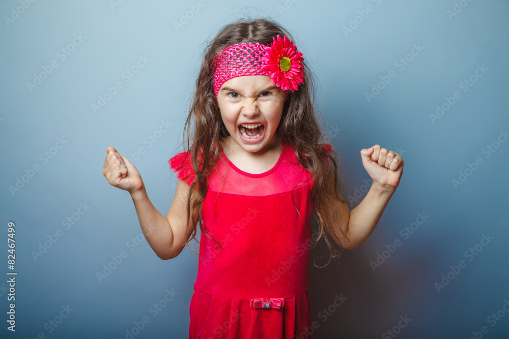 Girl European appearance haired child of seven in red bright dre Girl European appearance haired child of seven in red bright dre