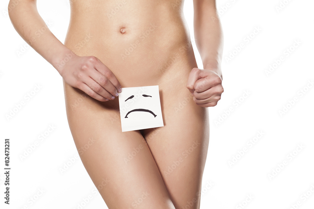 woman covering her crotch with a sad character drawn on paper Stock Photo