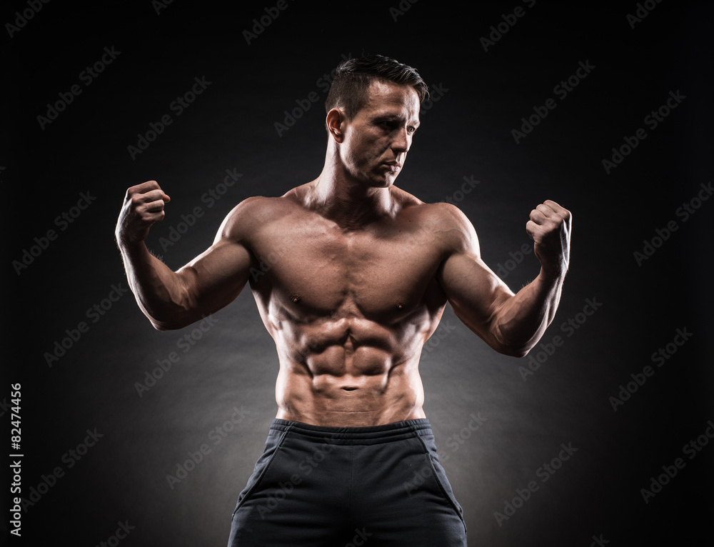 Muscular guy on black background