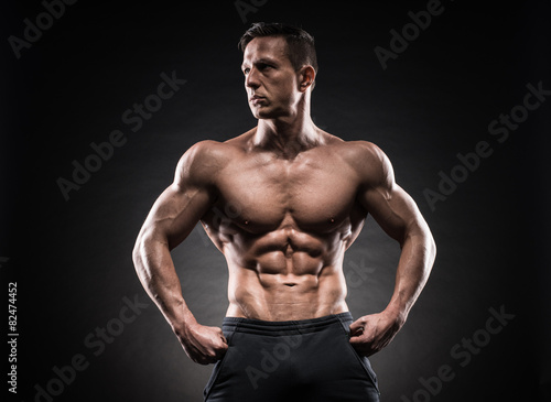 Muscular guy on black background