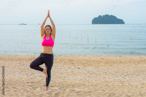 Thai woman poses a standing asana yoga or vriksasana