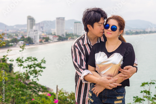Romantic Asian couple kissing. Happy Thai man and woman photo