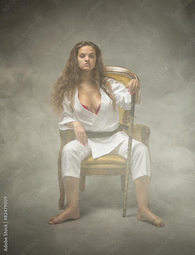 sexy judo girl sitting on sofa foto de Stock | Adobe Stock