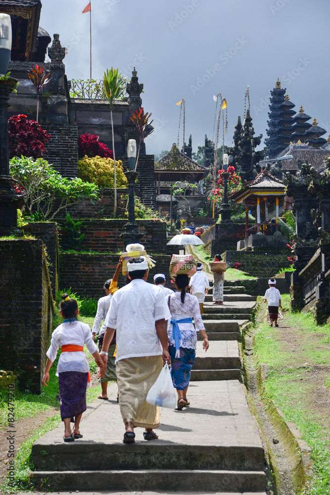 Balinese people walk in traditional dress in Pura Besakih