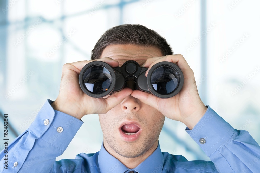 BinocularsMarketing. Business man watching his finances grow BinocularsMarketing. Business man watching his finances grow